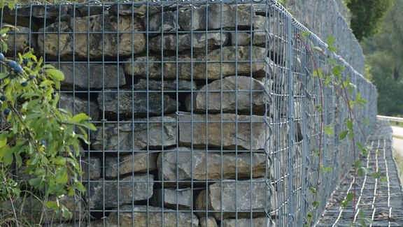 Titel der Produktbroschüre BauStatik - Geotechnik. Zu sehen ist eine Hangbefestigung aus Gabionen.